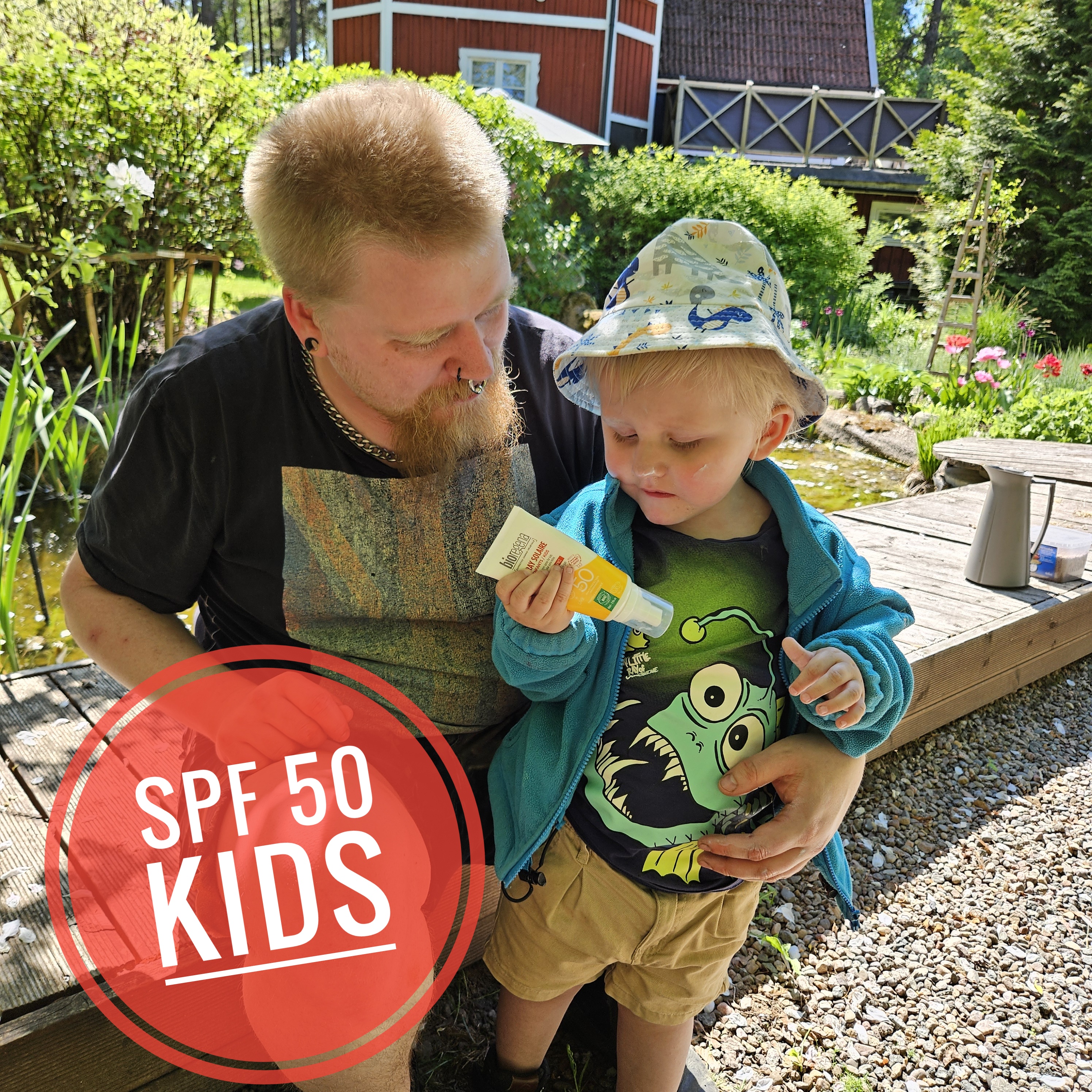 Pappa smörjer sitt barn med solskydd