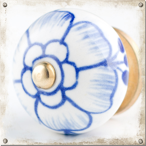 White ceramic cupboard knob with large blue flower Nillas