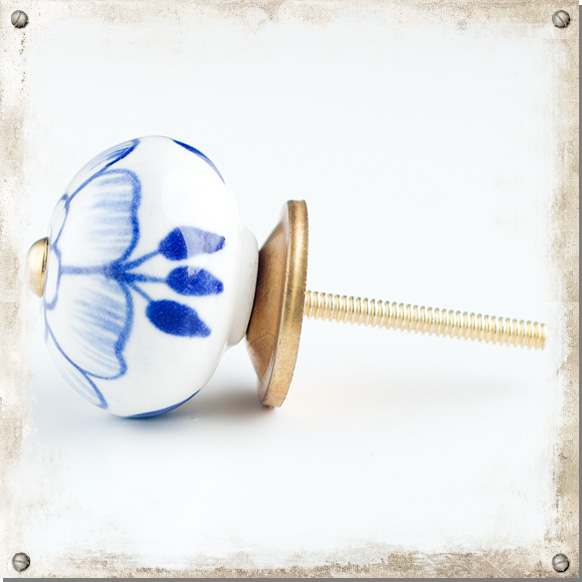 White ceramic cupboard knob with large blue flower Nillas
