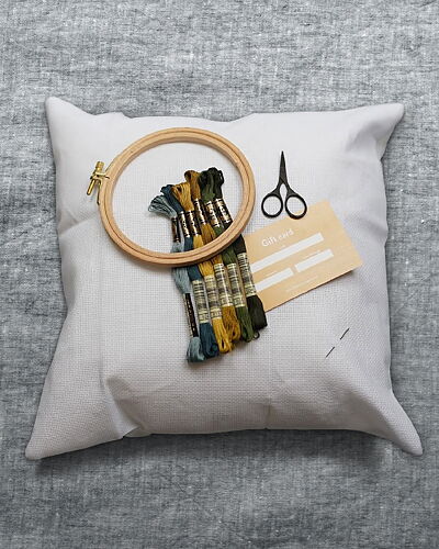Starter-kit including aida pillow case, floss, needle, notions and gift card