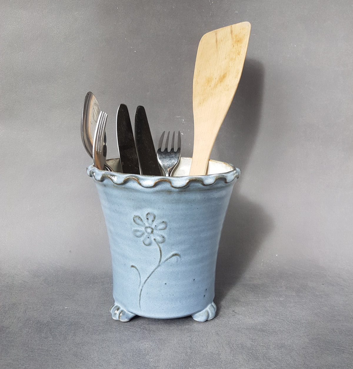 Blue ceramic utensil drainer with wavy rim