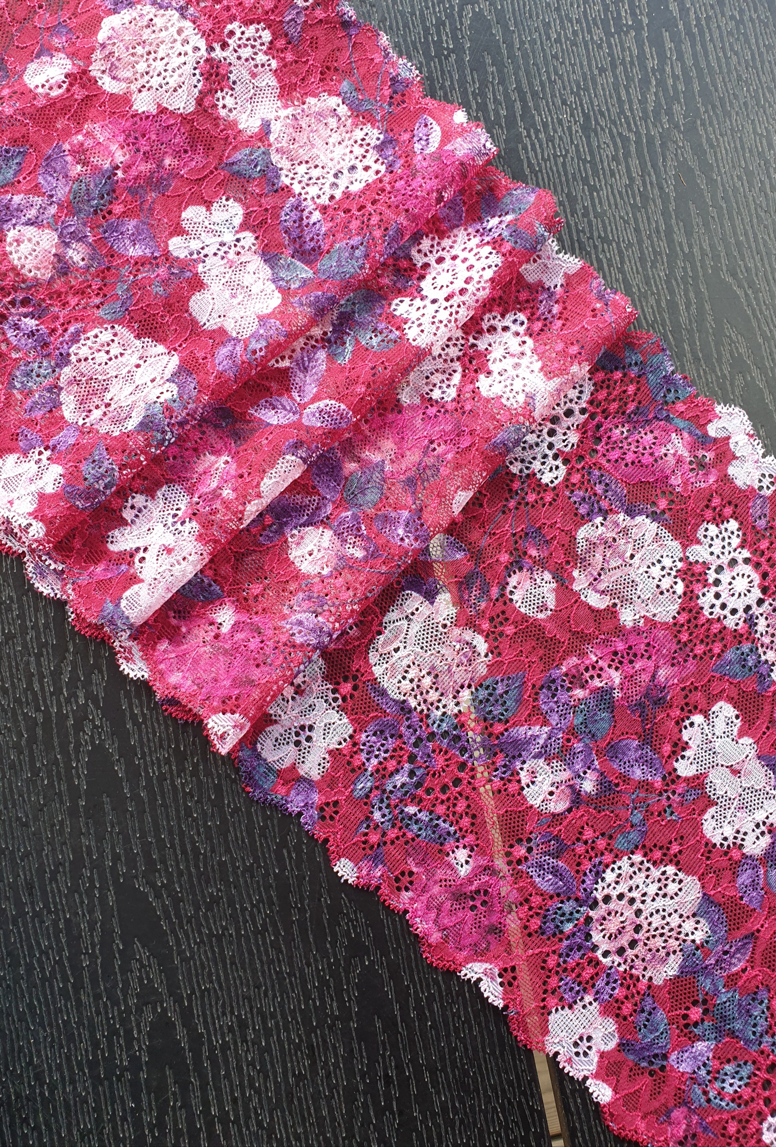 Raspberryred stretch lace with happy coloured  flowers - 20 cm