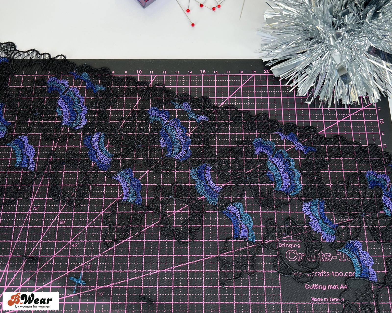 Beautiful embroided non-stretch tulle in black with bluepurple flowers - 15 cm