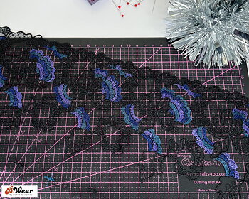 Beautiful embroided non-stretch tulle in black with bluepurple flowers - 15 cm