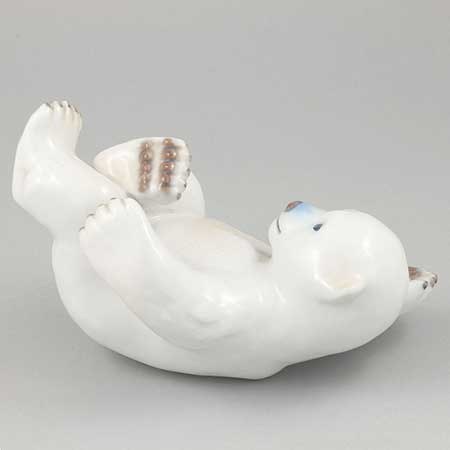 Merete Agergaard Bing & Gröndahl and Royal Copenhagen Polar bear cub on back, model 537. Manufactured by Bing & Grøndahl as model 2537 before the 1987 merger with Royal Copenhagen