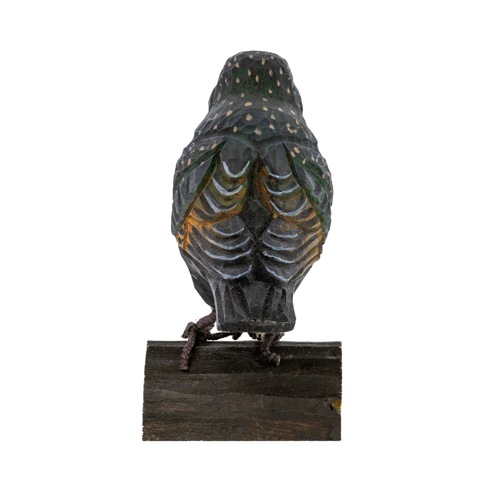DecoBird Starling seen from the back, standing on a small wooden base against a light background.