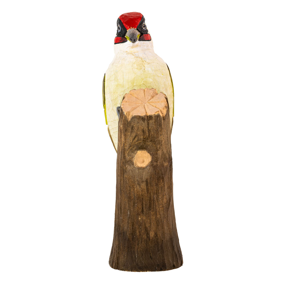 DecoBird Green Woodpecker viewed from the front, perched behind a tree trunk against a white background.