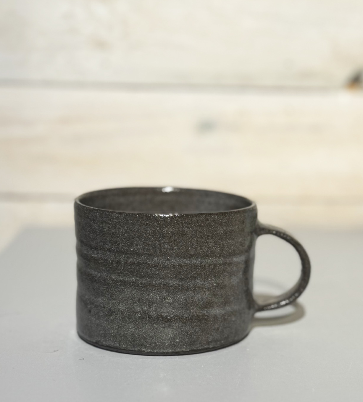 WAVE teacup in a brown clay