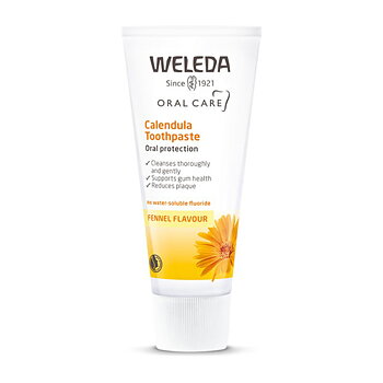 En vit och gul tandkrämstub som det står weleda calendula toothpaste på