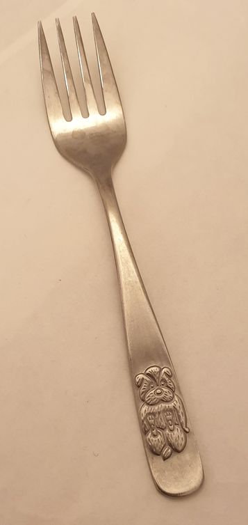 Teddy bear sitting, lined fur, fork