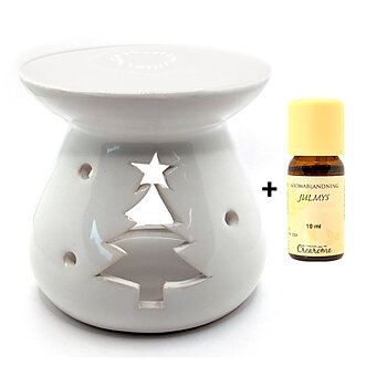 En vit glacerad aromalykta med julmotiv tillsammans med den eteriska oljan julmys