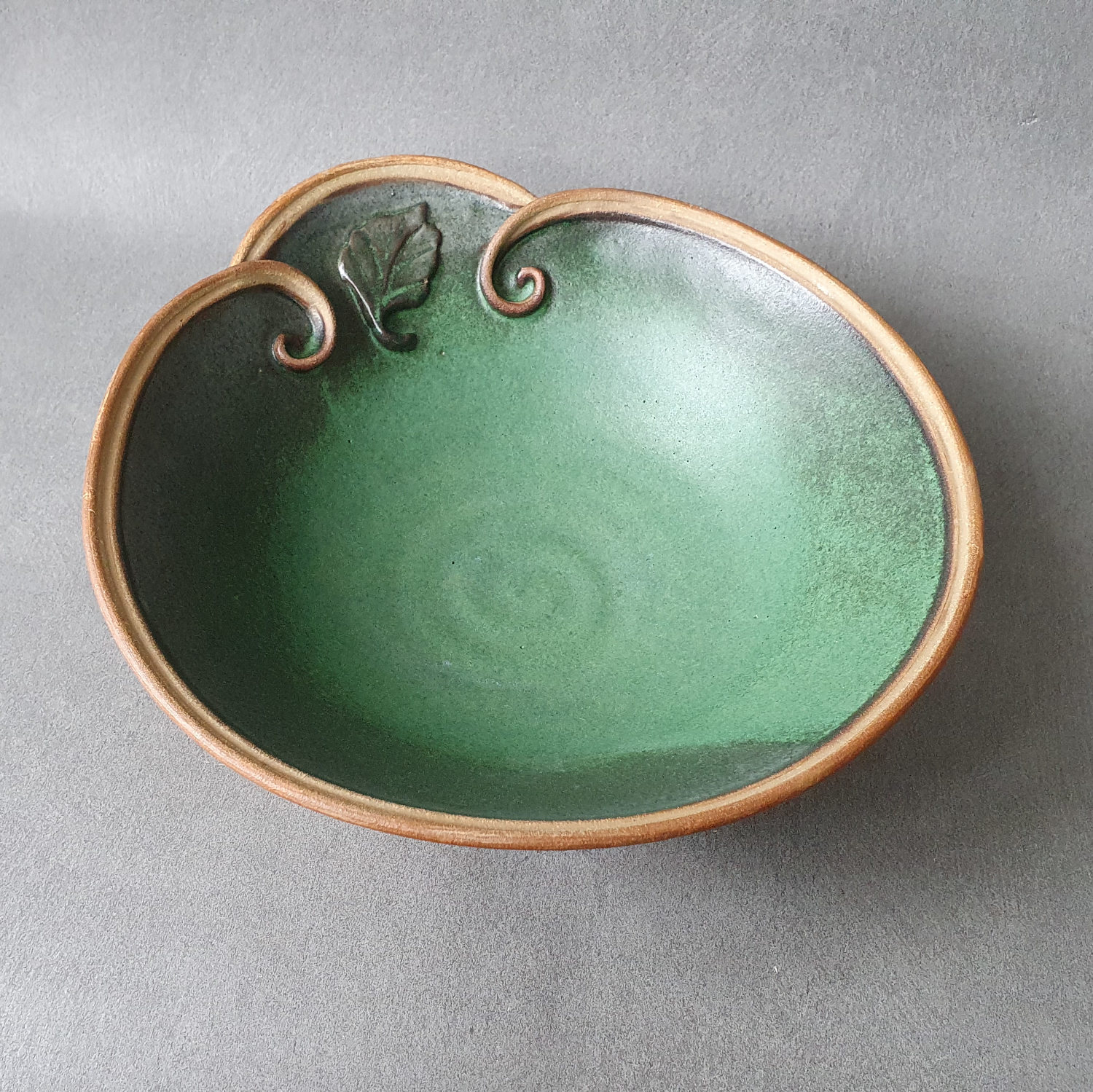 Forest green bowl with swirls and leaf