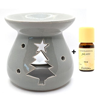 en grå aromalykta med jultema och en liten glasflaska bredvid med etrisk olja juldoft