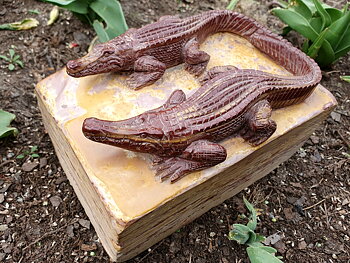 Sculpted crocodiles on a pedestal, cut from a single piece of mookaite.