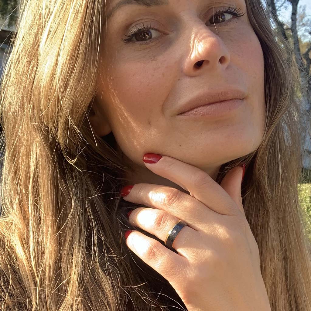 Female model wearing ring Black Hammer Star - Exclusive women's ring Luxurious Black titanium ring with hammered surface in black & gold with AAA CZ diamond.