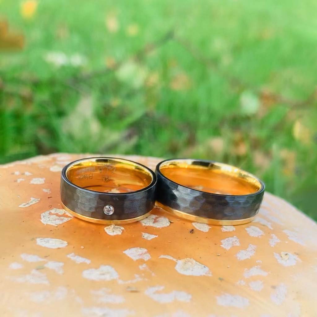 Ring Black Hammer photographed on a fly agaric. Exclusive package with Luxury Black titanium ring with hammered surface in black & gold and with sparkling AAA CZ diamond on the ladies ring. Perfect engagement ring wedding ring Luxury ring