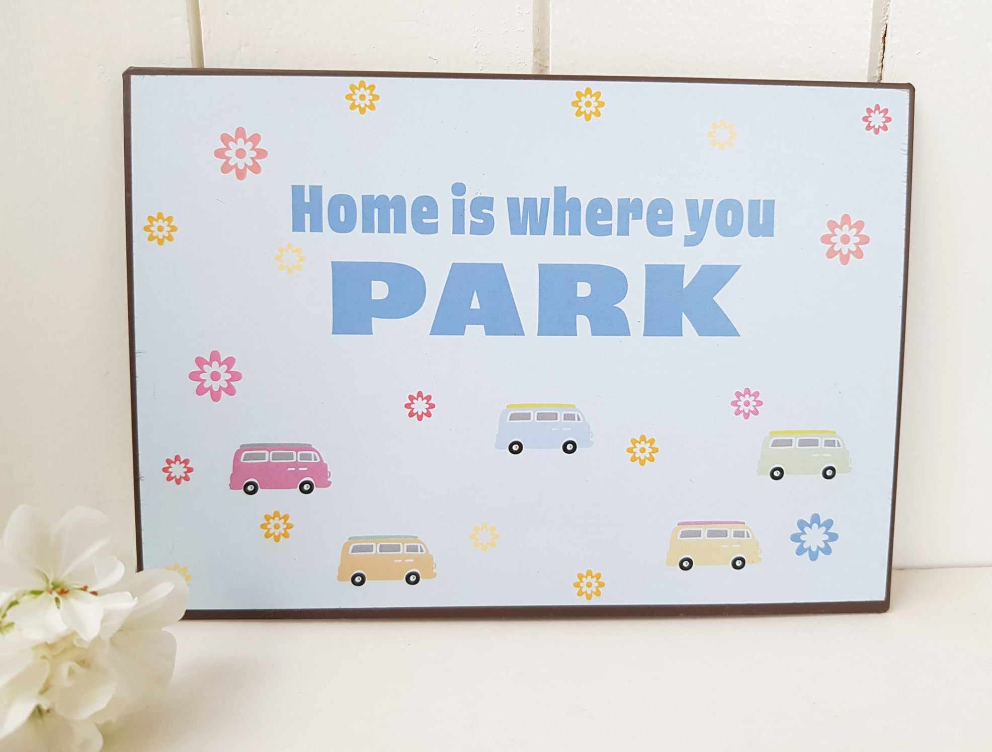 Skylt " Home is ..."