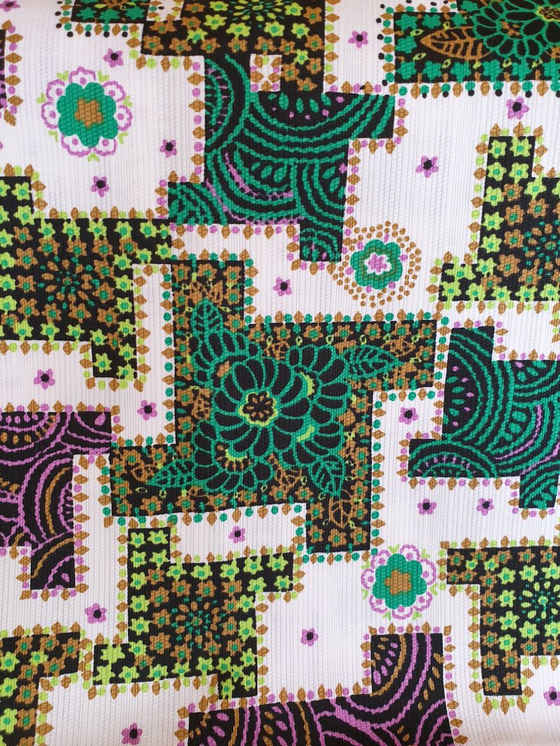 Fabric 1970s abstract pattern green, purple, brown, black on white background
