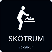 Taktil Skylt 150x150 Toalett, svart med vit text