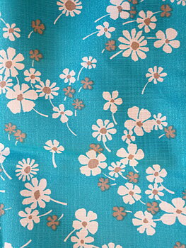 Polyester fabric, white and rose beige flowers on a turquoise background