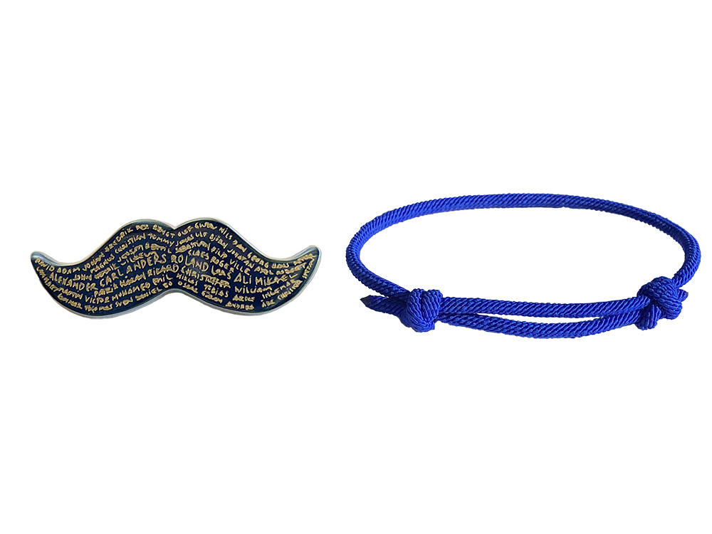 Limiterad mustachpin för 2024 och ett blått armband