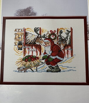 Jultavla. Tomten matar Rudolf.