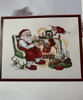 Jultavla. Tomten läser godnattsaga för Rudolf.