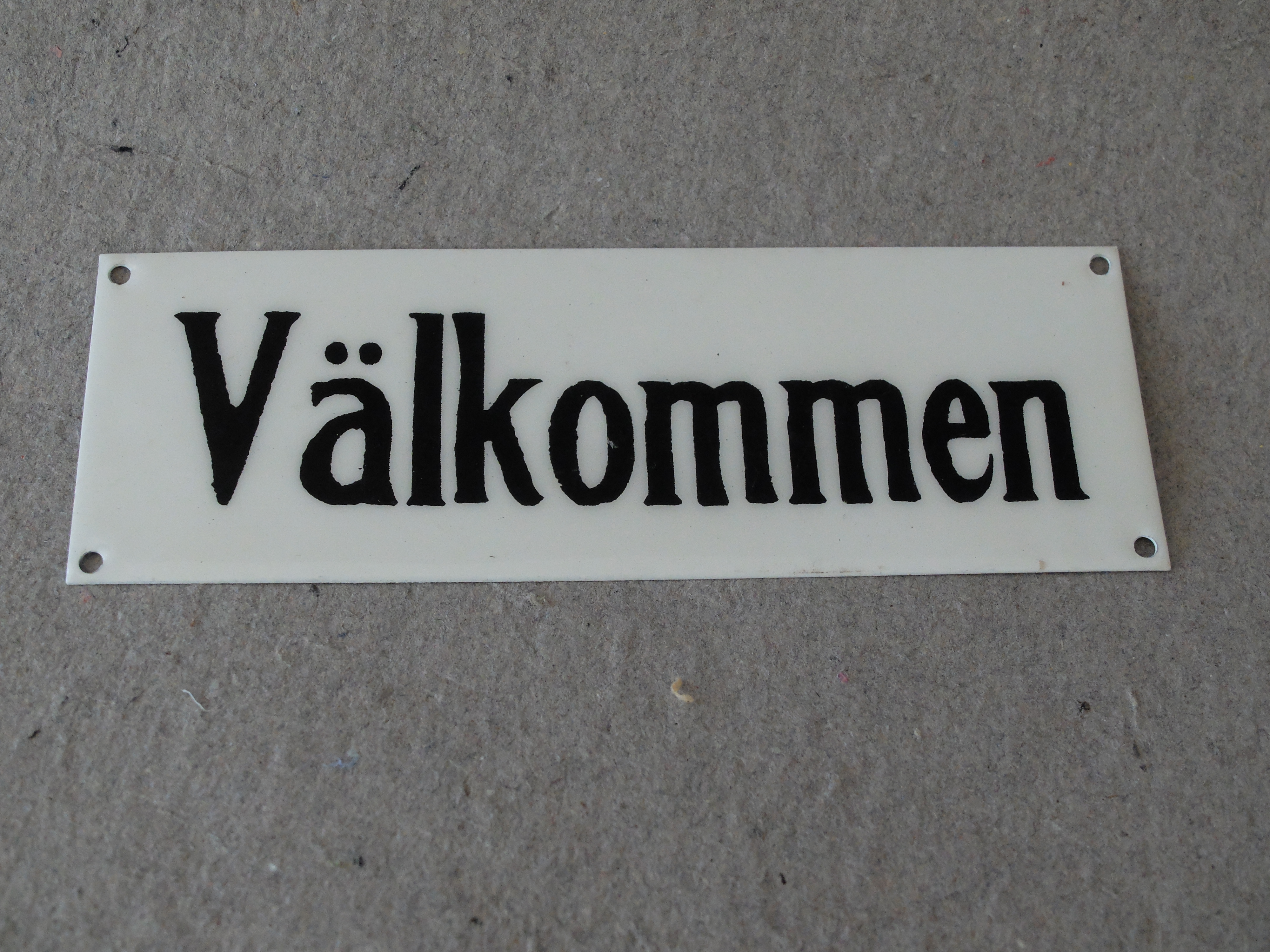 Skylt-Väkommen