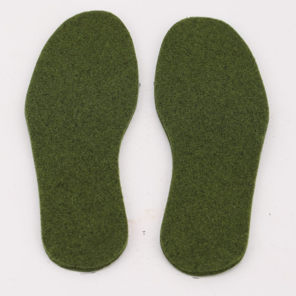A pair of felted wool insoles in the color green