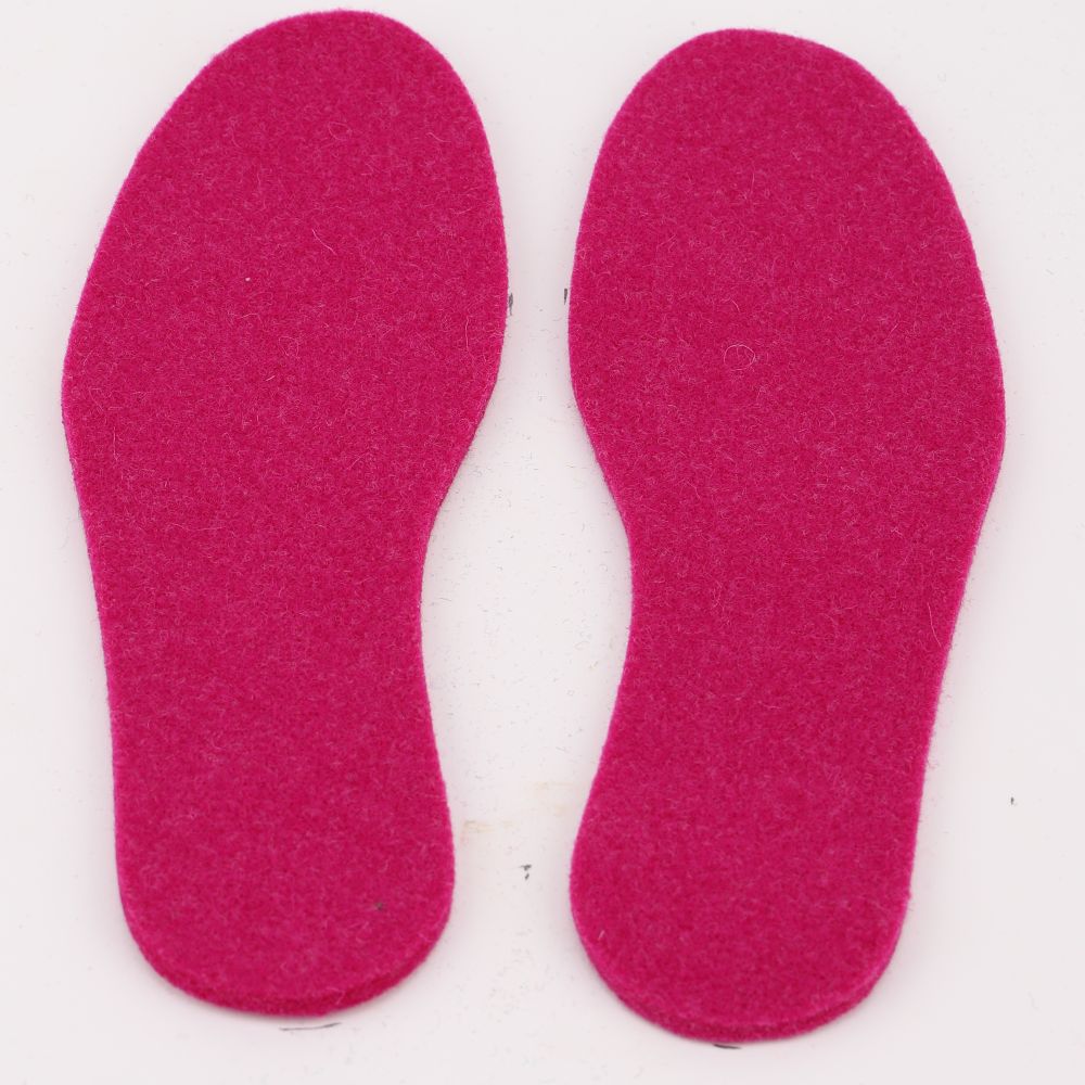 A pair of felted wool insoles in the color cerise