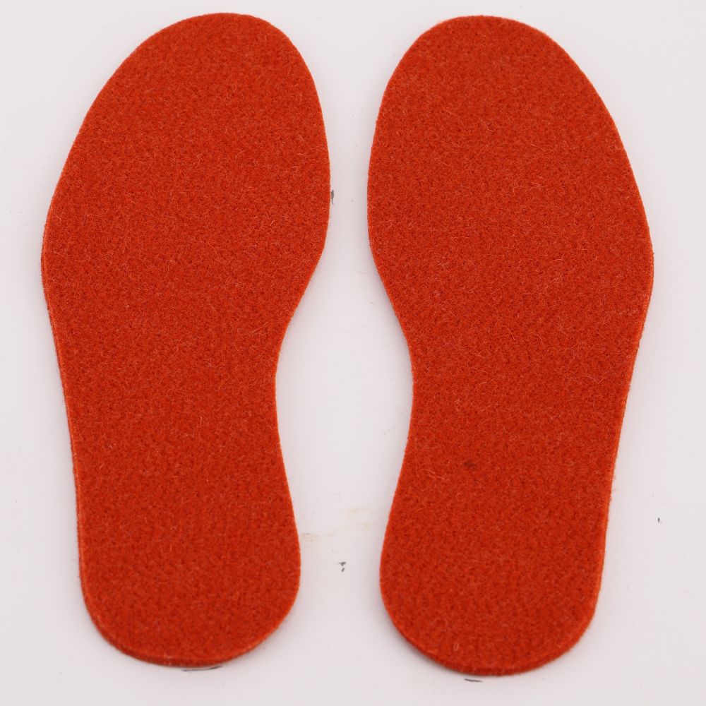 A pair of felted wool insoles in the color orange