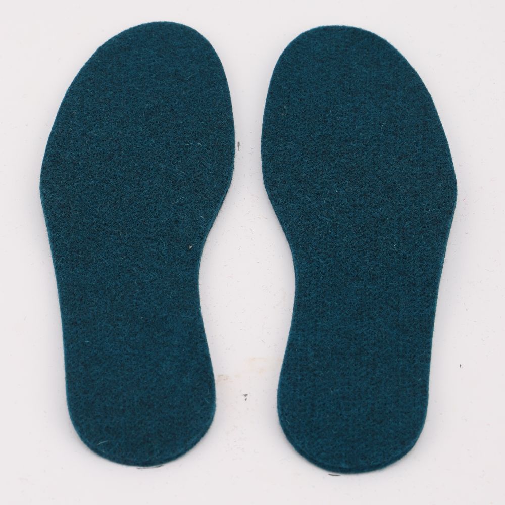 A pair of felted wool insoles in the color aqua blue