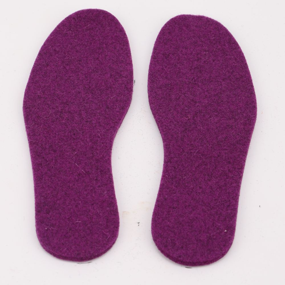 A pair of felted wool insoles in the color cyclamen purple