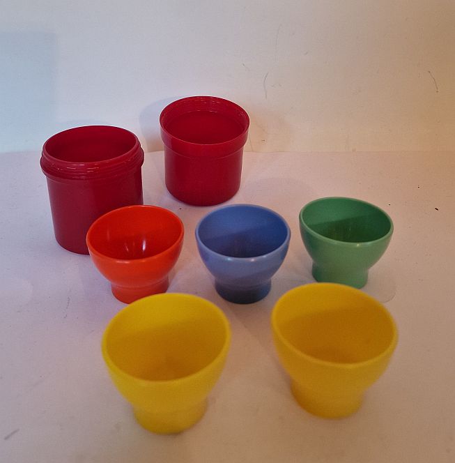 Plastic egg cups in bakelite holder