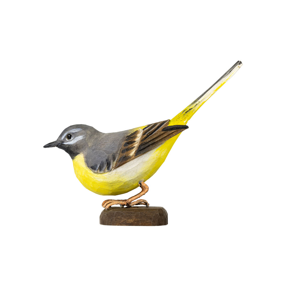 DecoBird Grey Wagtail shown in side view, with the hand-carved grey and yellow bird standing on its wooden base.