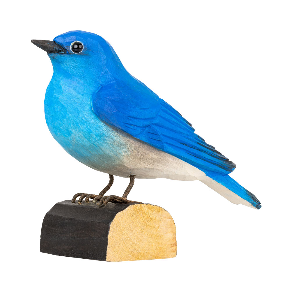 Three-quarter view of DecoBird Mountain Bluebird, showing the bright blue hand-carved bird on its wooden base.