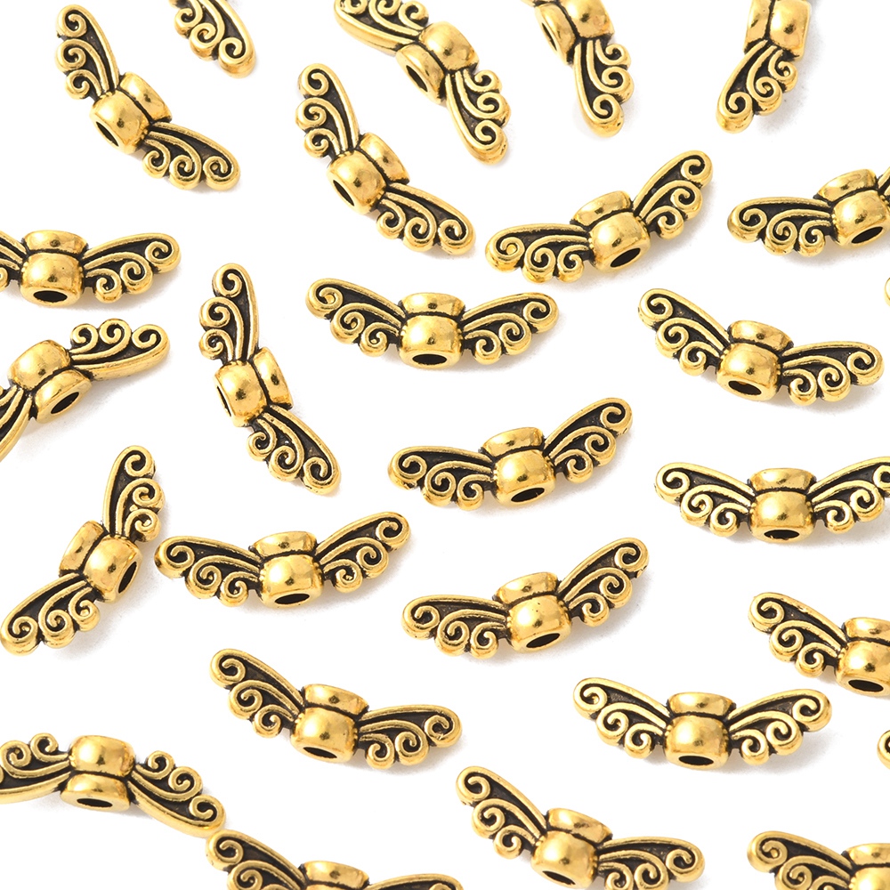 Antikguldfärgade metallpärlor formade som fe- eller änglavingar, ca 14 mm, 10-pack