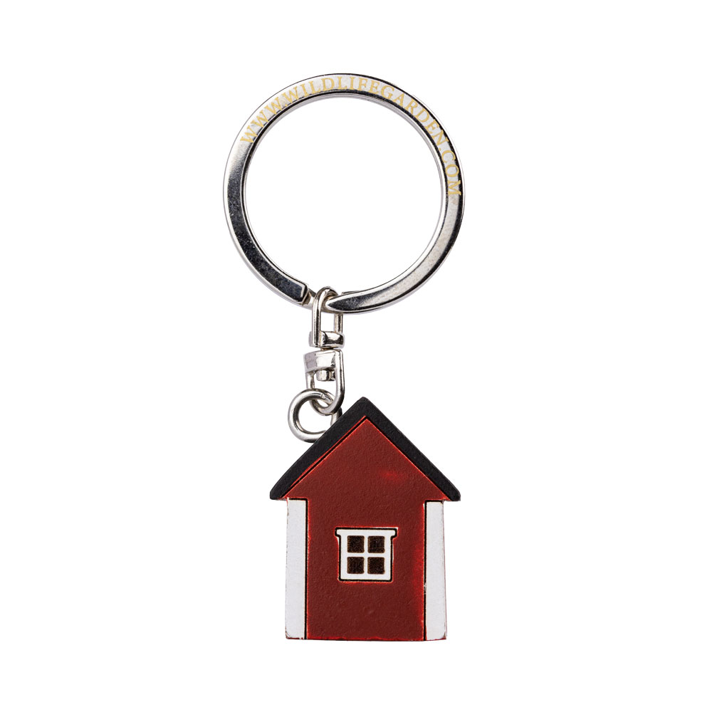 Porte-clés Maison Rouge vu de dos sur fond clair.