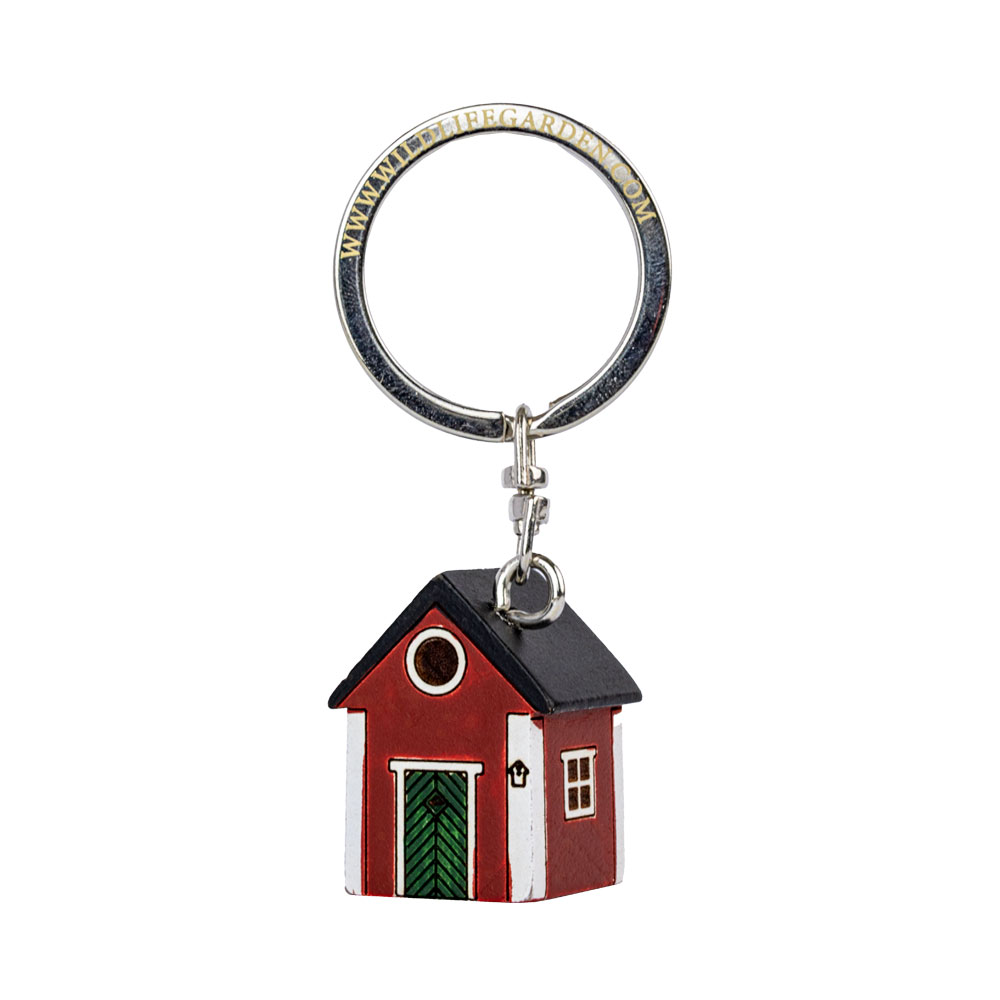 Porte-clés Maison Rouge vu de trois quarts sur fond clair.