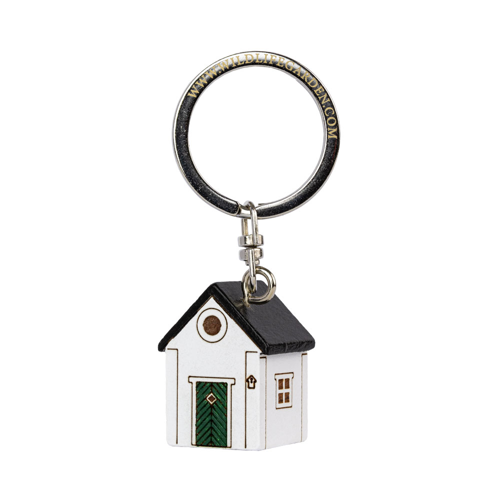 Porte-clés Petite Maison Blanche vu de trois quarts sur fond clair.