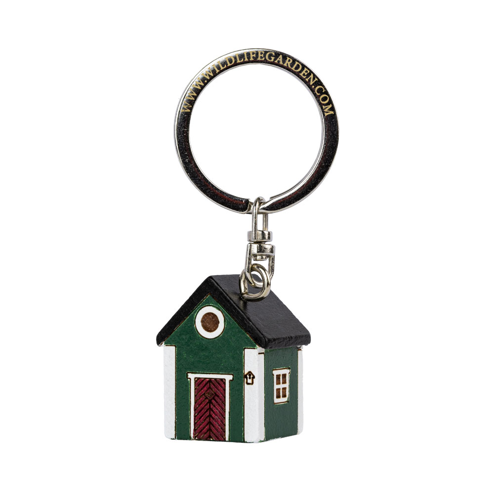 Porte-clés Maison Verte vu de trois quarts sur fond clair.
