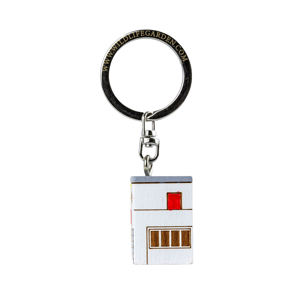 Porte-clés De Stijl vu de côté sur fond clair.