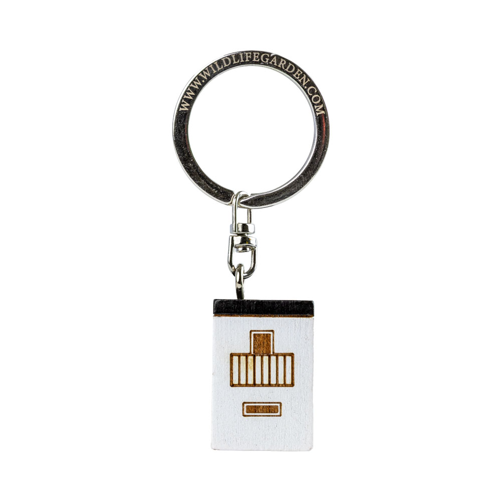 Porte-clés Maison Moderne vu de côté sur fond clair.