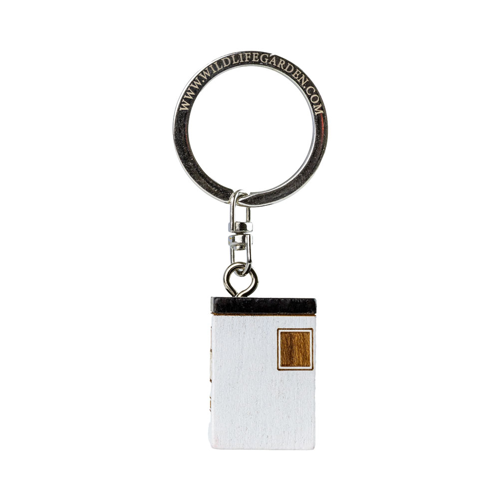 Porte-clés Maison Moderne vu de dos sur fond clair.