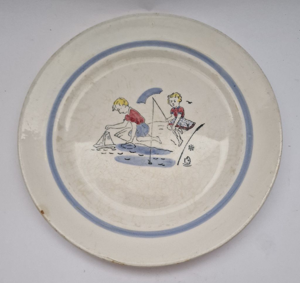 Children's plate playing children by water