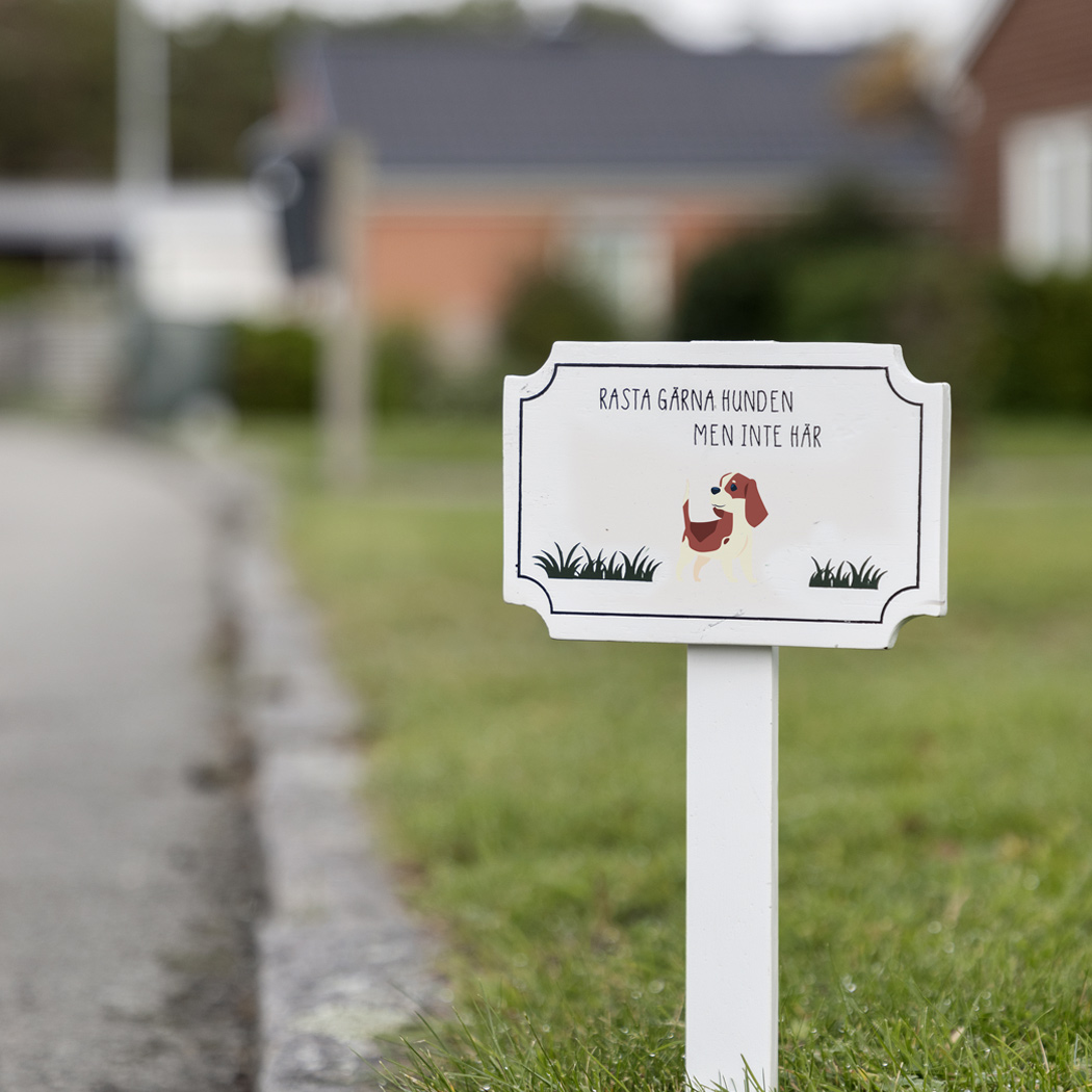 Skylt i trä med text: Rasta gärna hunden men inte här - 2