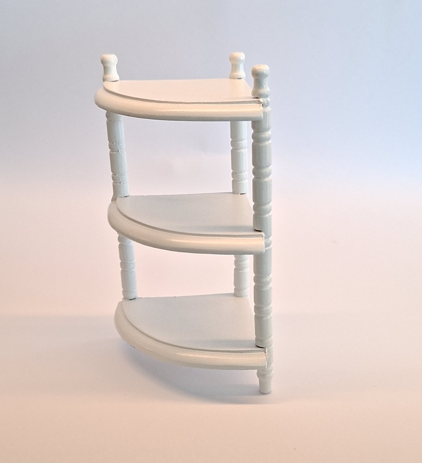 White corner shelf with three shelves