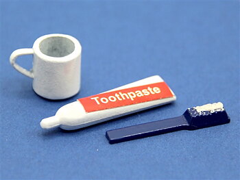 Toothpaste tube, cup, and toothbrush