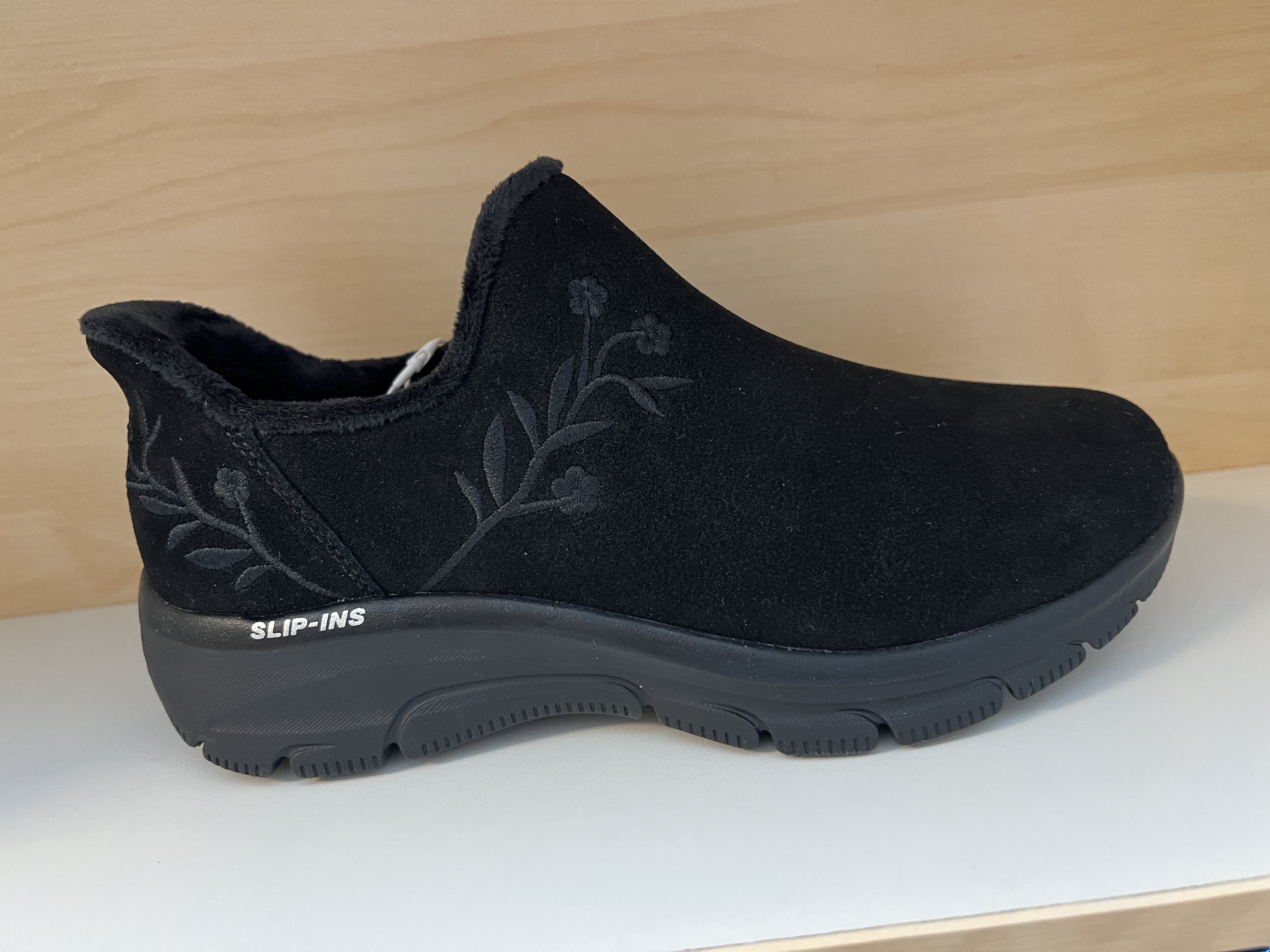 Skechers Rymliga "Relaxed Fit" Slip-on- Damkänga i svart Scotchgard-behandlad mocka med broderat blommotiv.  AirCooled, Memory Foam vadderad innersula. Fodrad. (Relaxed Fit= Bredare både höjd och bredd. Fokus på att tårna ska vara fria och kunna andas.