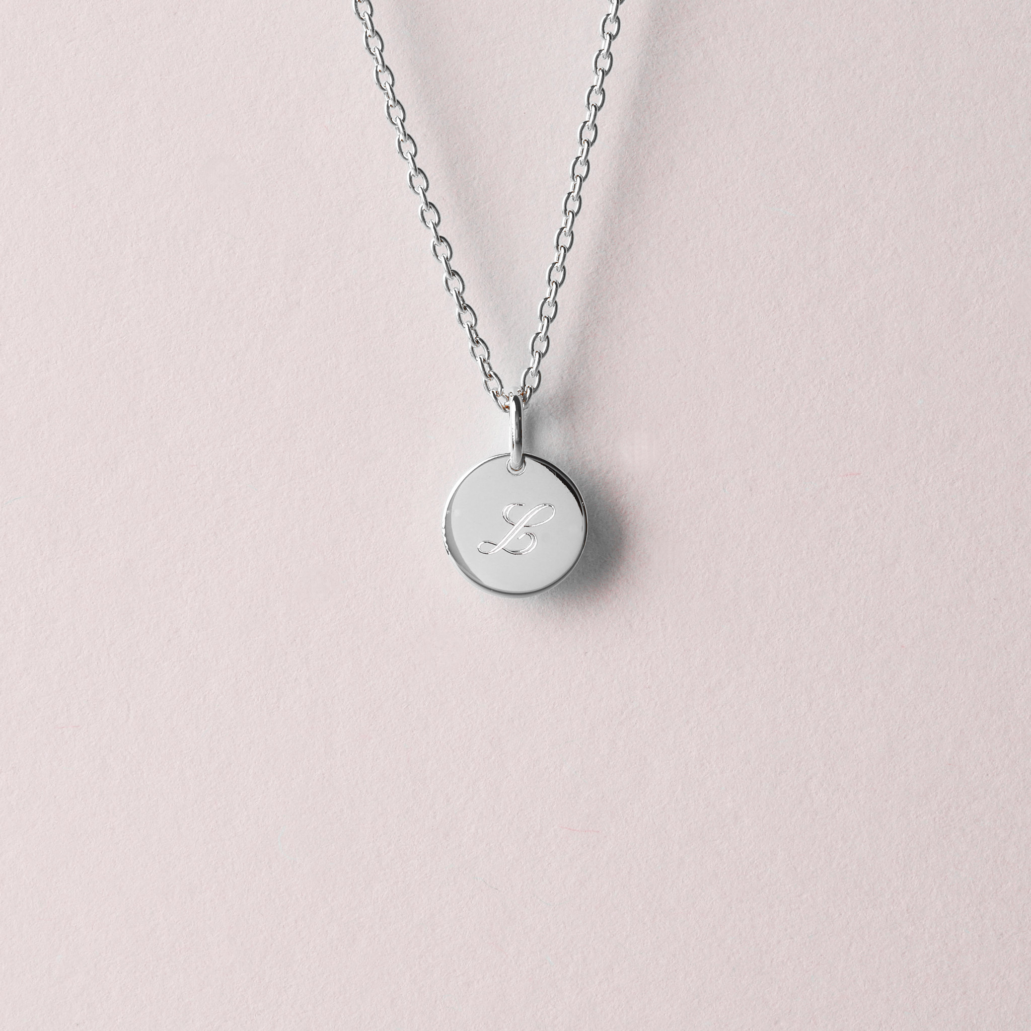 Silver necklace with a round pendant. Engravable.